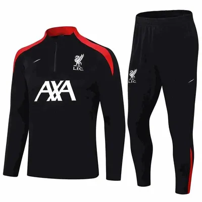 Black football training top with red shoulder panels, shown with matching black training pants