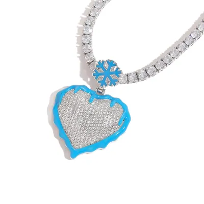 Blue enamel heart pendant set with small crystals, hanging from a close-set crystal chain